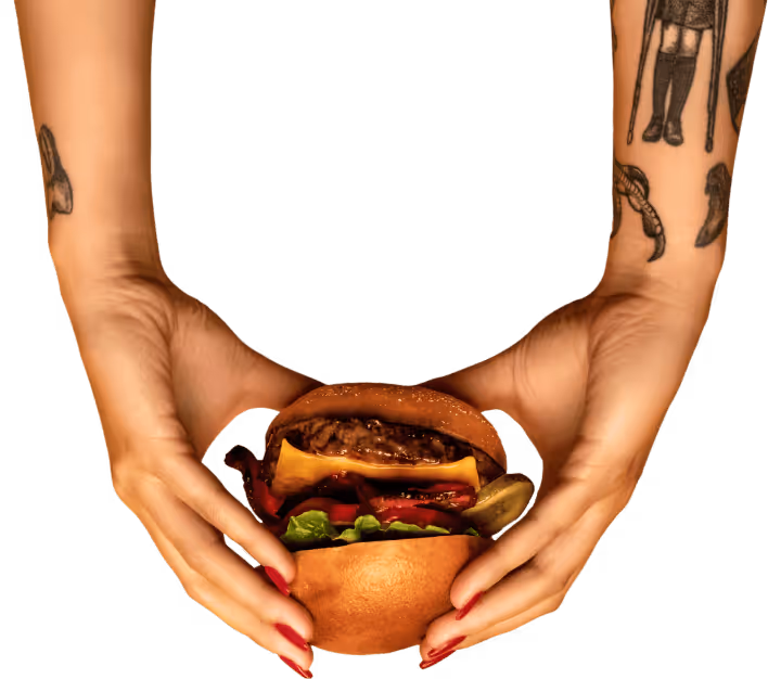 Two hands holding a cheeseburger