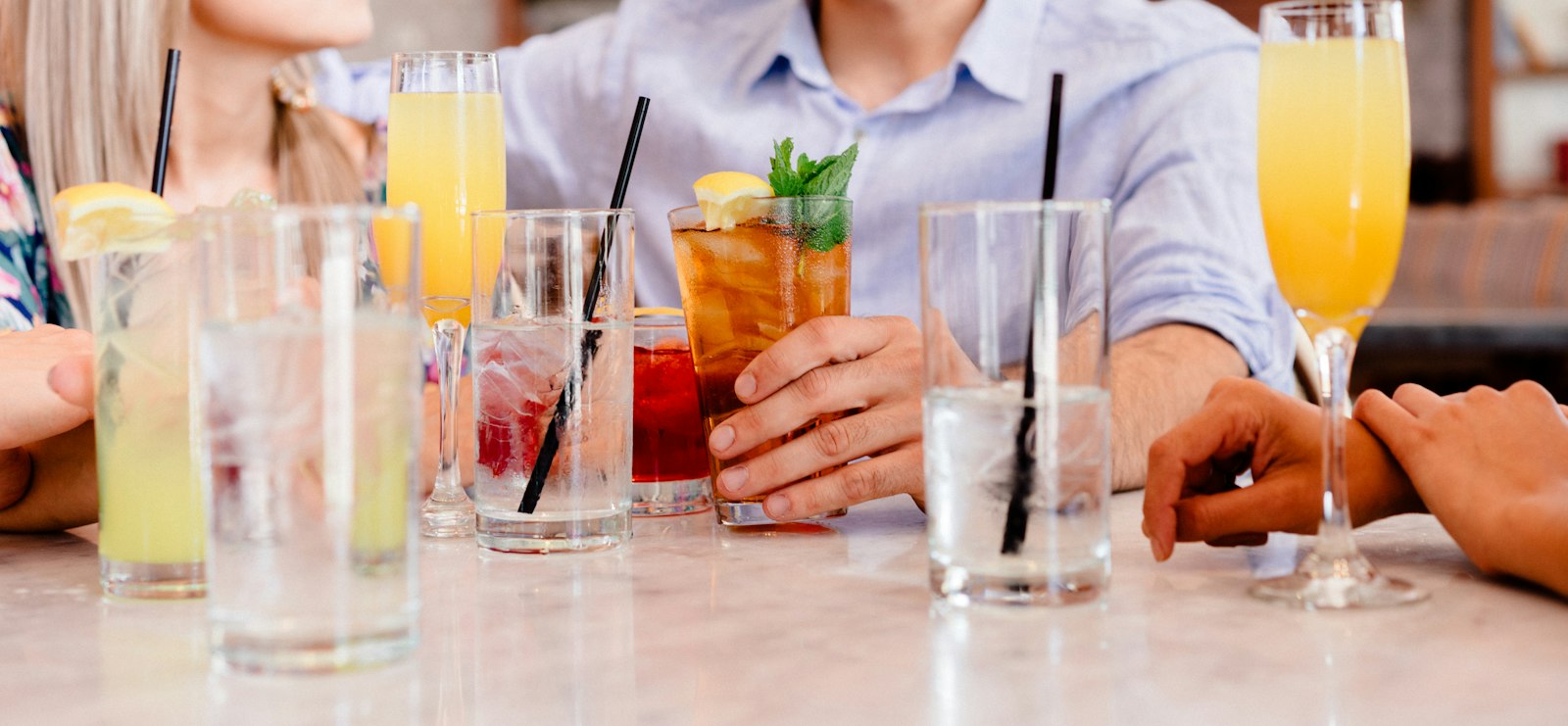 Friends raising their drinks around a table
