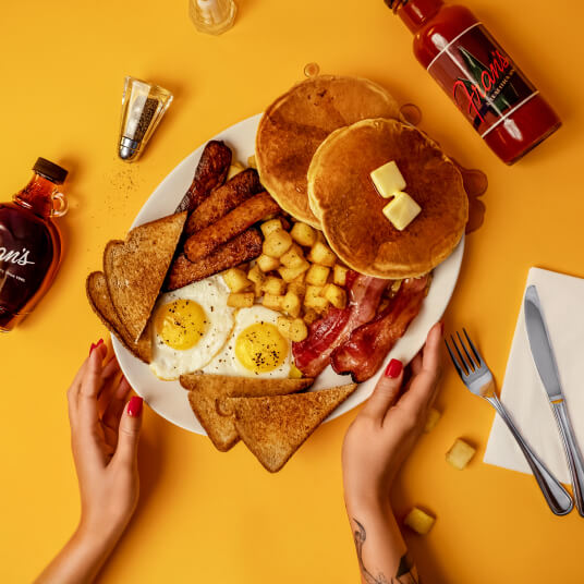 The Big Breakfast with eggs, bacon, sausages, pancakes, homefries and toast